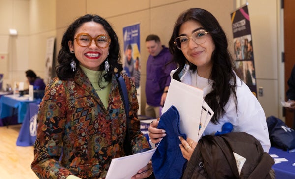 Two students smile at a career fair